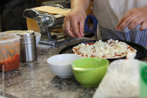 hand of chef making pizza at homemade kitchen