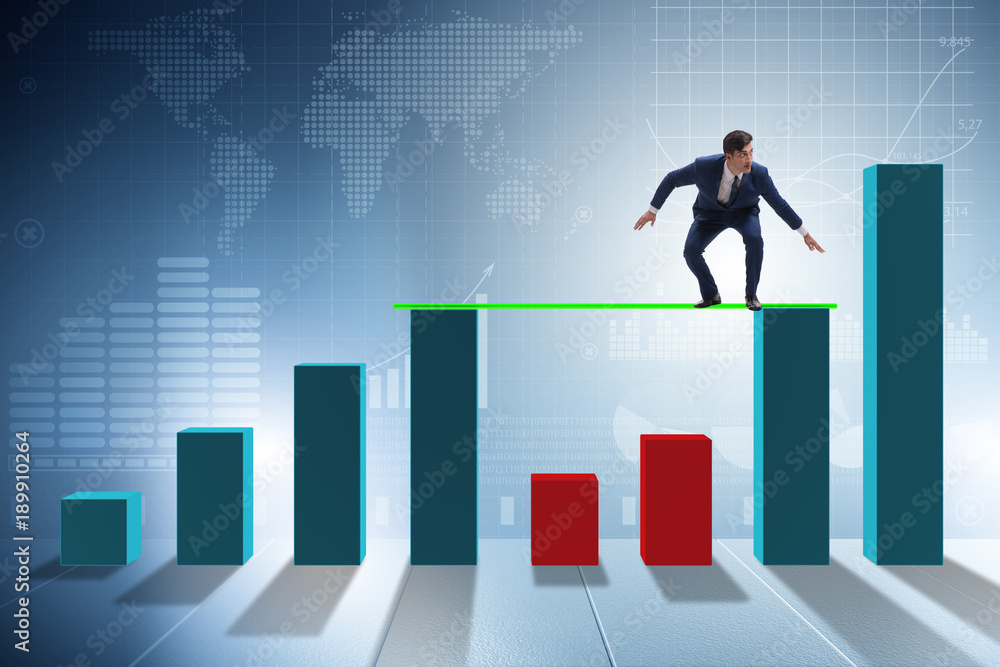 Young businessman in business concept with bar charts Young businessman in business concept with bar charts