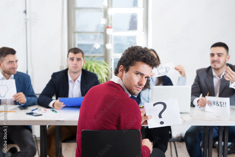 Young businessman with qouestion mark wondering Young businessman with qouestion mark wondering