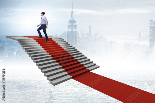 Photography Young businessman climbing stairs and red carpet