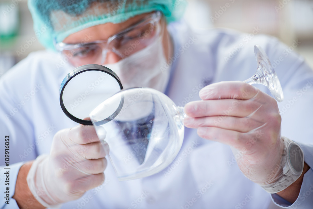 Forensics investigator working in lab on crime evidence Forensics investigator working in lab on crime evidence