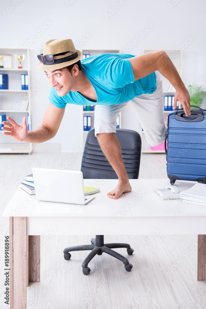 Businessman preparing for vacation in the office Businessman preparing for vacation in the office