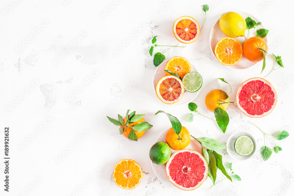 Fruit background. Colorful fresh fruits on white table. Orange, tangerine, lime, lemon, grapefruit. Flat lay, top view, copy space Fruit background. Colorful fresh fruits on white table. Orange, tangerine, lime, lemon, grapefruit. Flat lay, top view, copy space