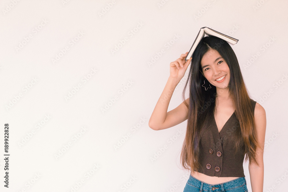 Young cute asian businesswoman holding a book and smiling with copy space - Education and back to school concept Young cute asian businesswoman holding a book and smiling with copy space - Education and back to school concept