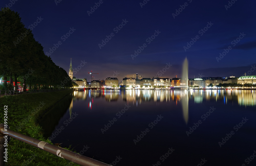 Hamburg Binnenalster at night with Alsterhaus and fountain in the background