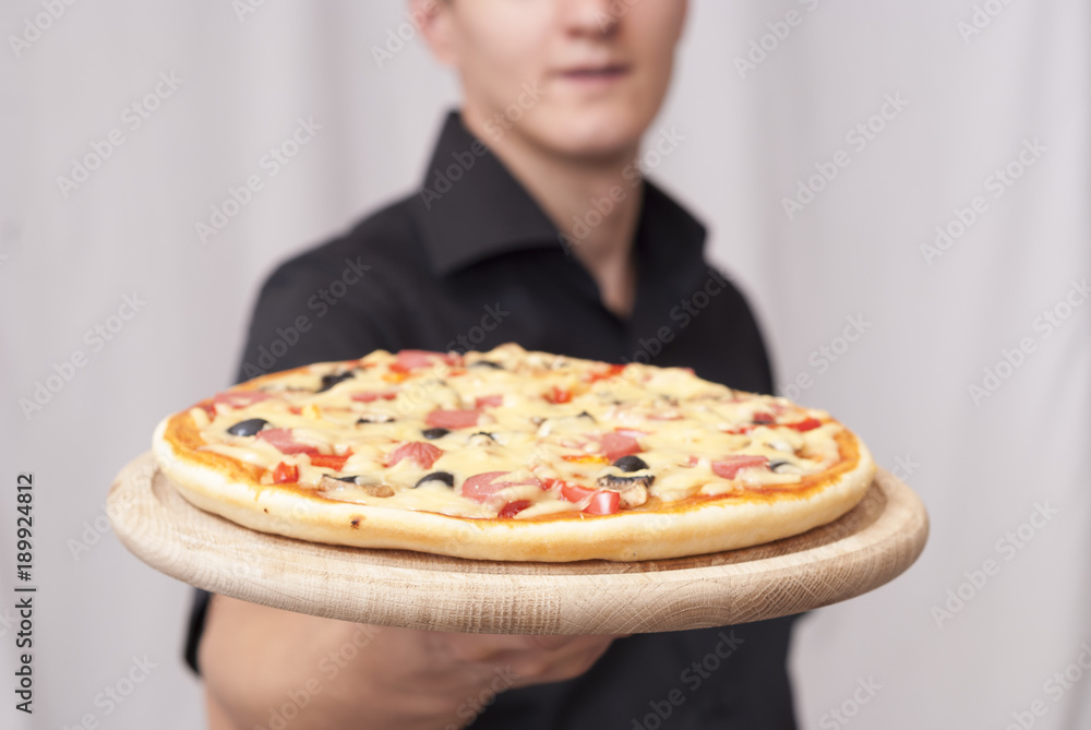 man holding a pizza