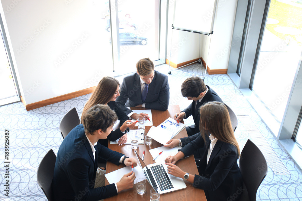 Business meeting in an office, the businesspeople are discussing a document. - obrazy, fototapety, plakaty 