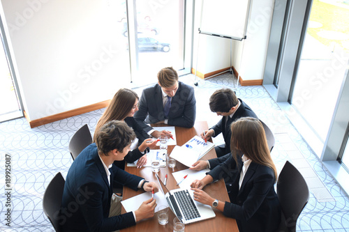 Business meeting in an office, the businesspeople are discussing a document. photo