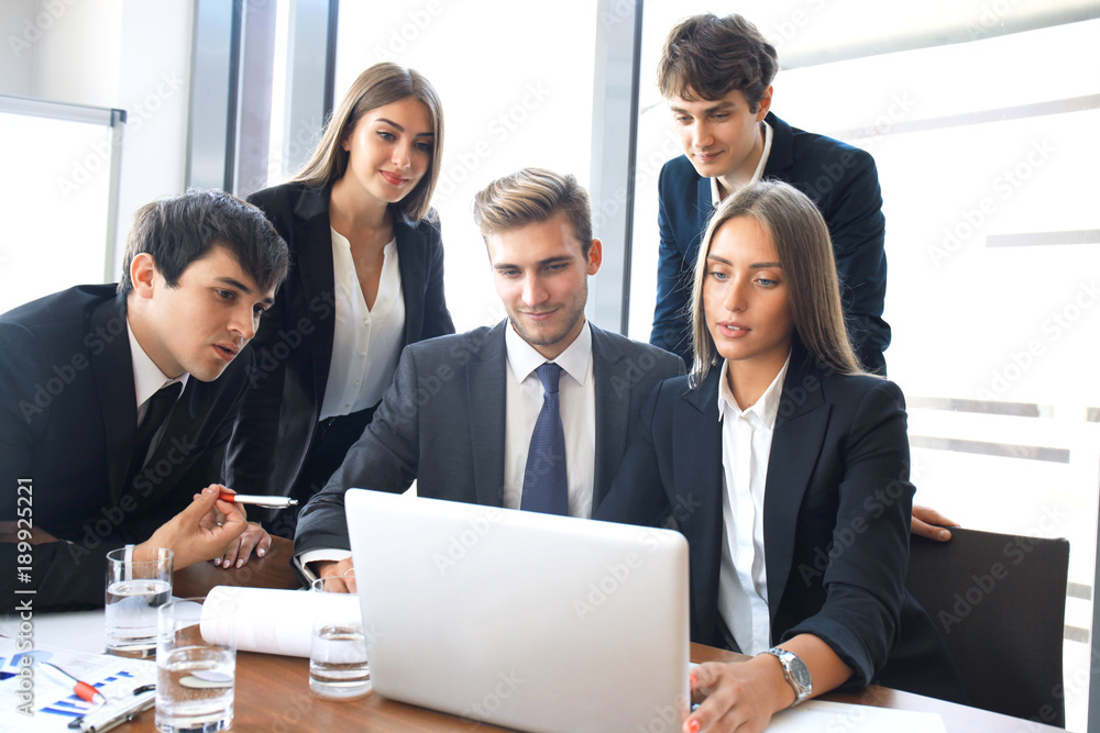 Startup business team on meeting in modern bright office interior and working on laptop. Startup business team on meeting in modern bright office interior and working on laptop.