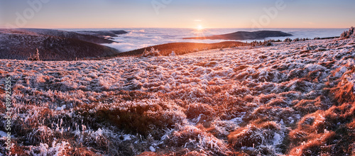 Horizontal panoramic photo of sunset at Czech mountains Jeseniky. Taken during the winter time with low clouds (inversion).