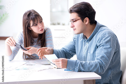 Young couple looking at family finance papers