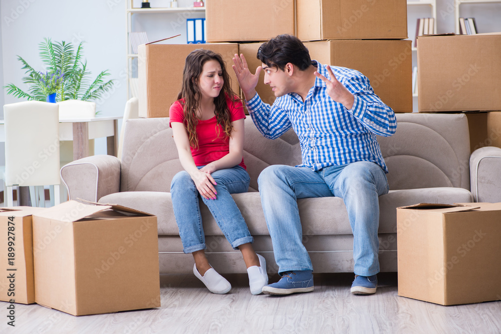 Young pair moving in to new house with boxes Young pair moving in to new house with boxes