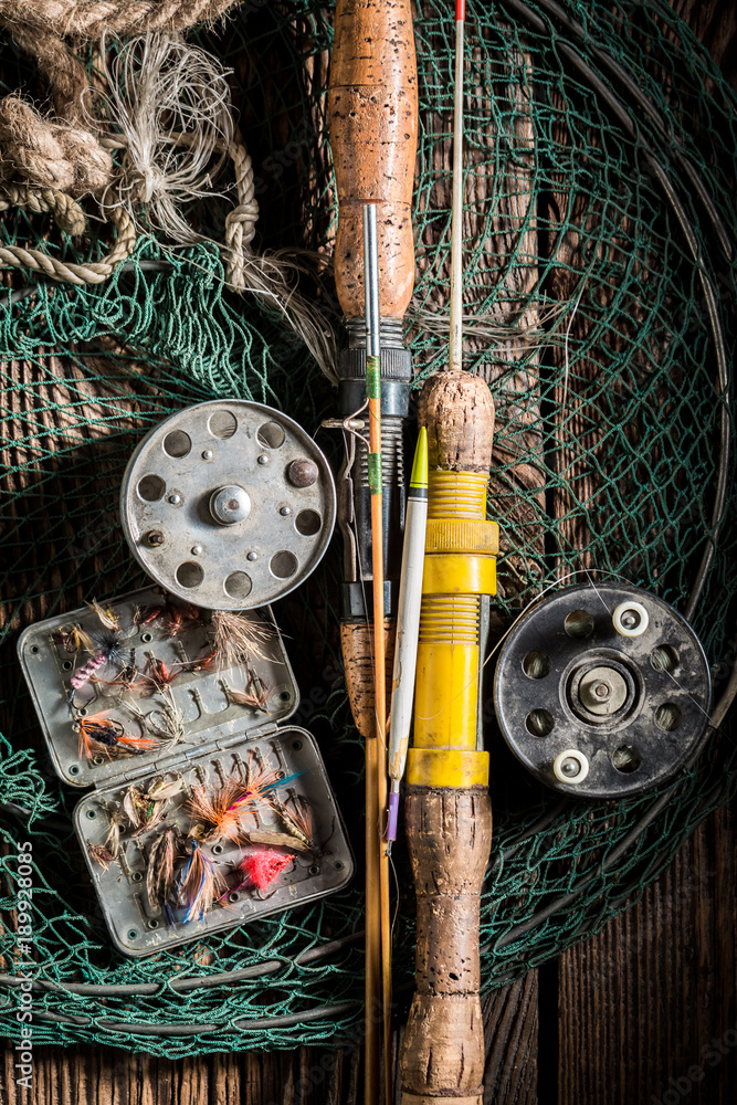 Old fishing tackle with fishing rod and lures Stock Photo
