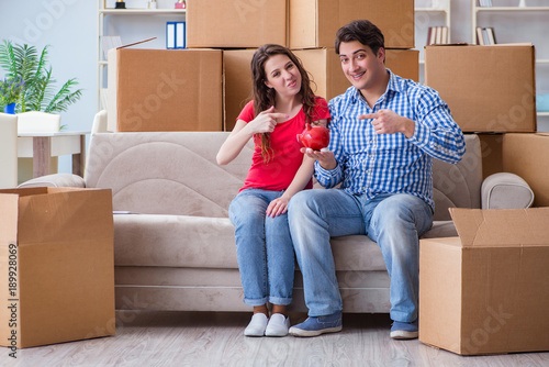 Young pair moving in to new house with boxes