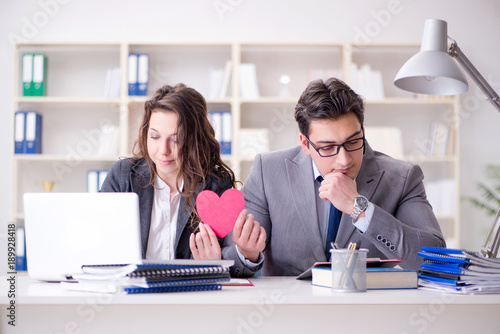 Happy couple working in the same office photo