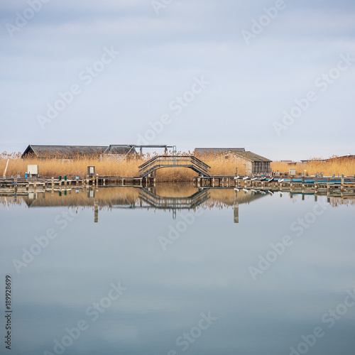 Neusiedlersee Brücke im Schilf mit Seehäusern photo