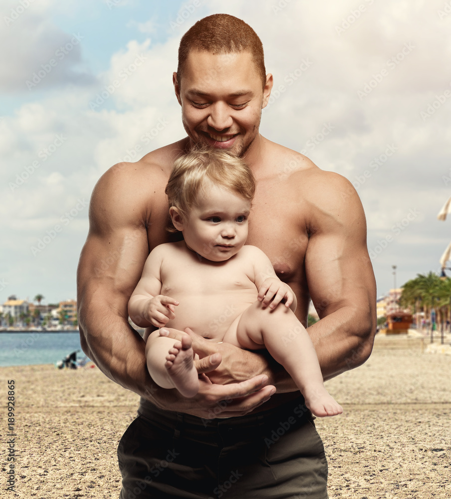 Athletic father with daughter on the beach Athletic father with daughter on the beach