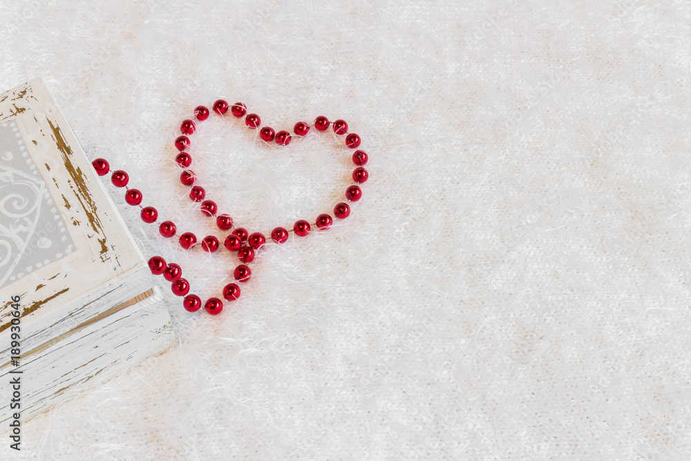 Heart shape made from red necklace on white background Heart shape made from red necklace on white background