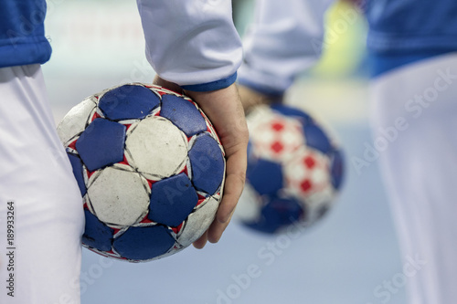 Handball players holding balls for handball