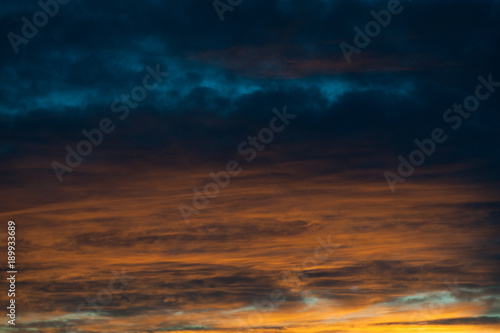 Beautiful sky with colorful clouds. Blue and orange clouds. Abstract wallpaper, background.