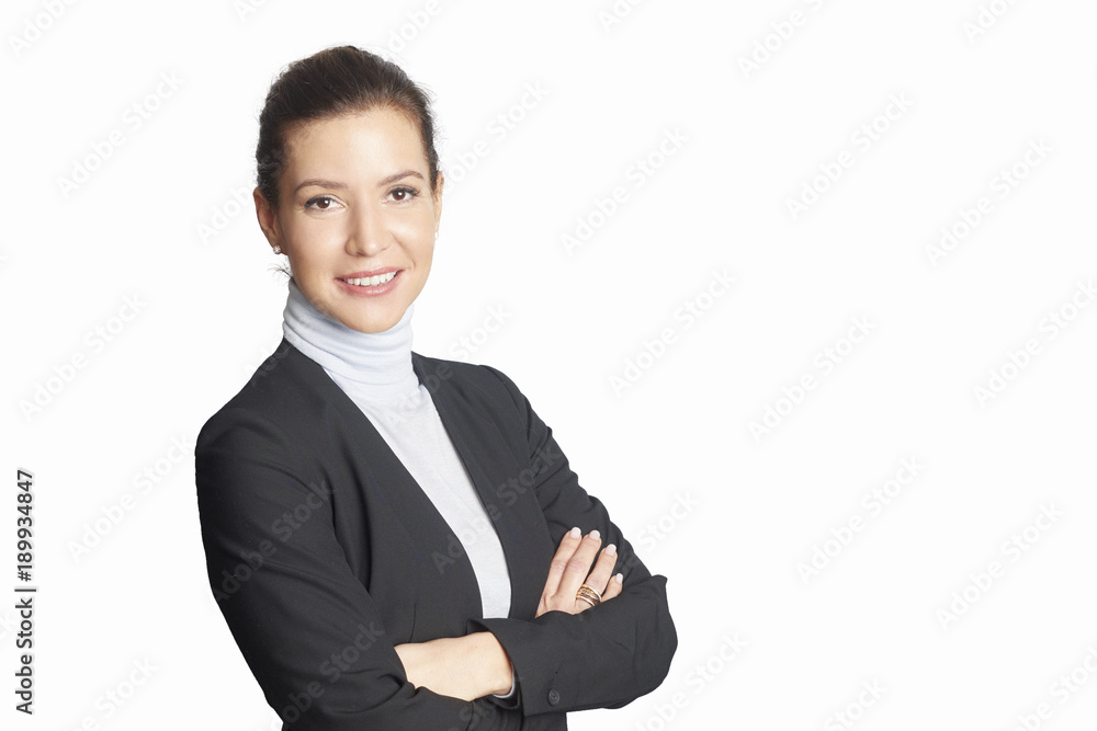 Executive mature businesswoman. A smiling middle aged woman wearing suit while standing with arms crossed and looking at camera at isolated white background. Executive mature businesswoman. A smiling middle aged woman wearing suit while standing with arms crossed and looking at camera at isolated white background.