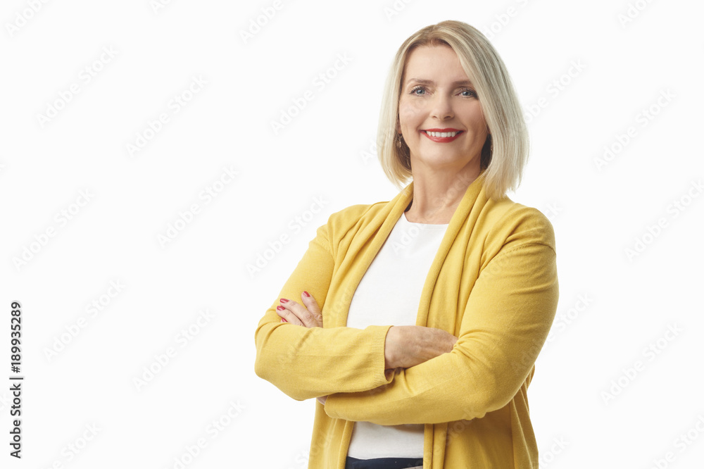 Beautiful smiling woman portrait. Elderly lady wearing casual clothes while standing at isolated white background. Beautiful smiling woman portrait. Elderly lady wearing casual clothes while standing at isolated white background.
