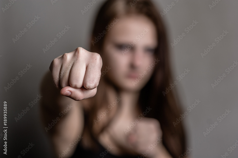 Sad girl is ready to fight, focused on the fist Sad girl is ready to fight, focused on the fist