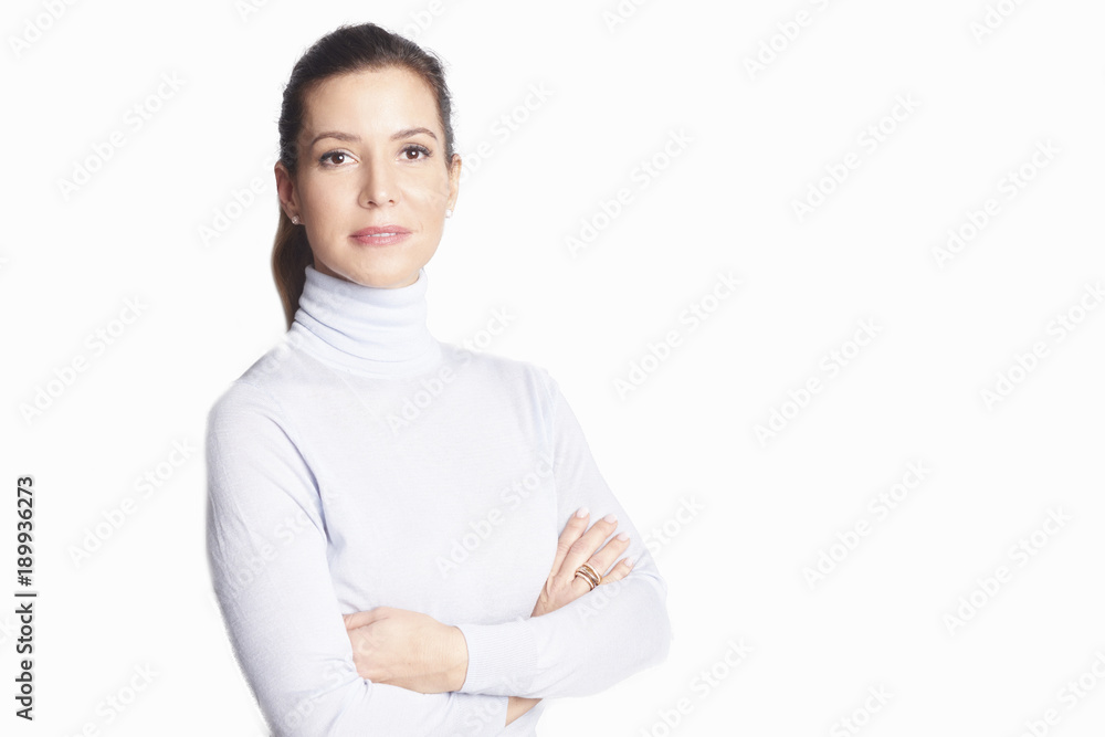 Confident mature woman. A smiling woman standing with arms crossed at isolated white background. Confident mature woman. A smiling woman standing with arms crossed at isolated white background.