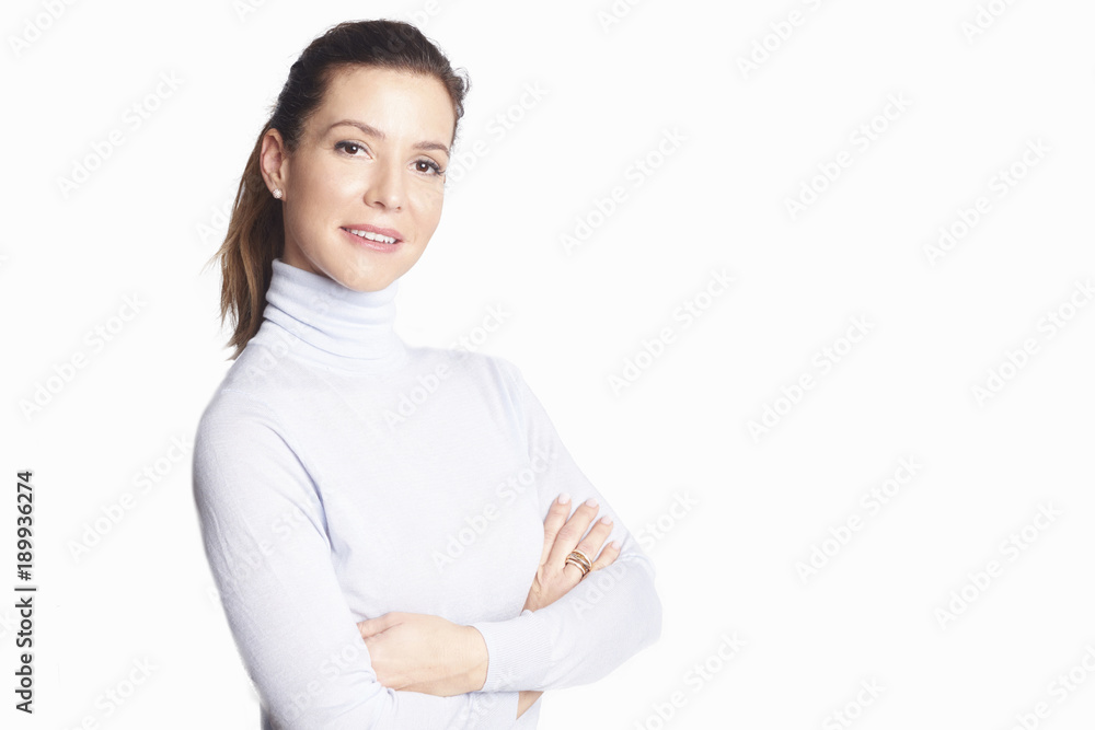 Confident mature woman. A smiling woman standing with arms crossed at isolated white background. Confident mature woman. A smiling woman standing with arms crossed at isolated white background.