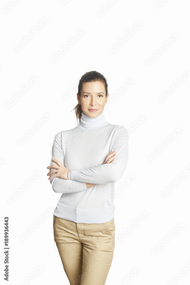 Confident mature woman. A smiling woman standing with arms crossed at isolated white background. Confident mature woman. A smiling woman standing with arms crossed at isolated white background.