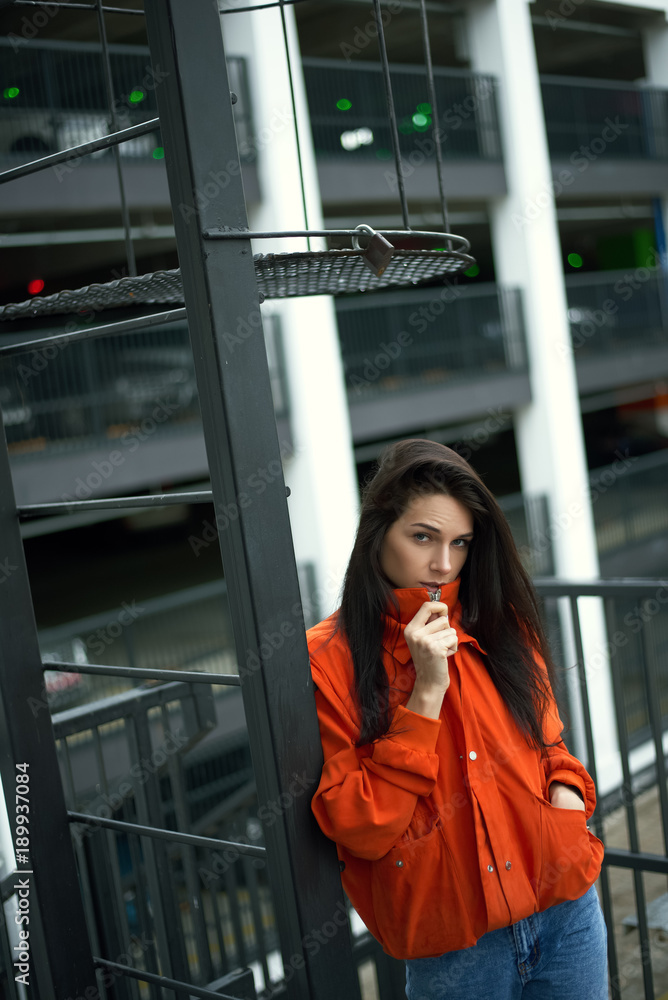 Fototapeta premium Portrait of young beautiful fashionable woman hippy in red jacket in the summer near the summer house