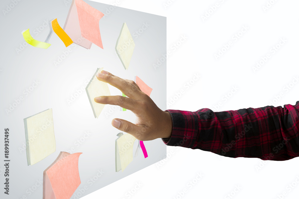 Unknown businessman putting sticky notes on studio Unknown businessman putting sticky notes on studio