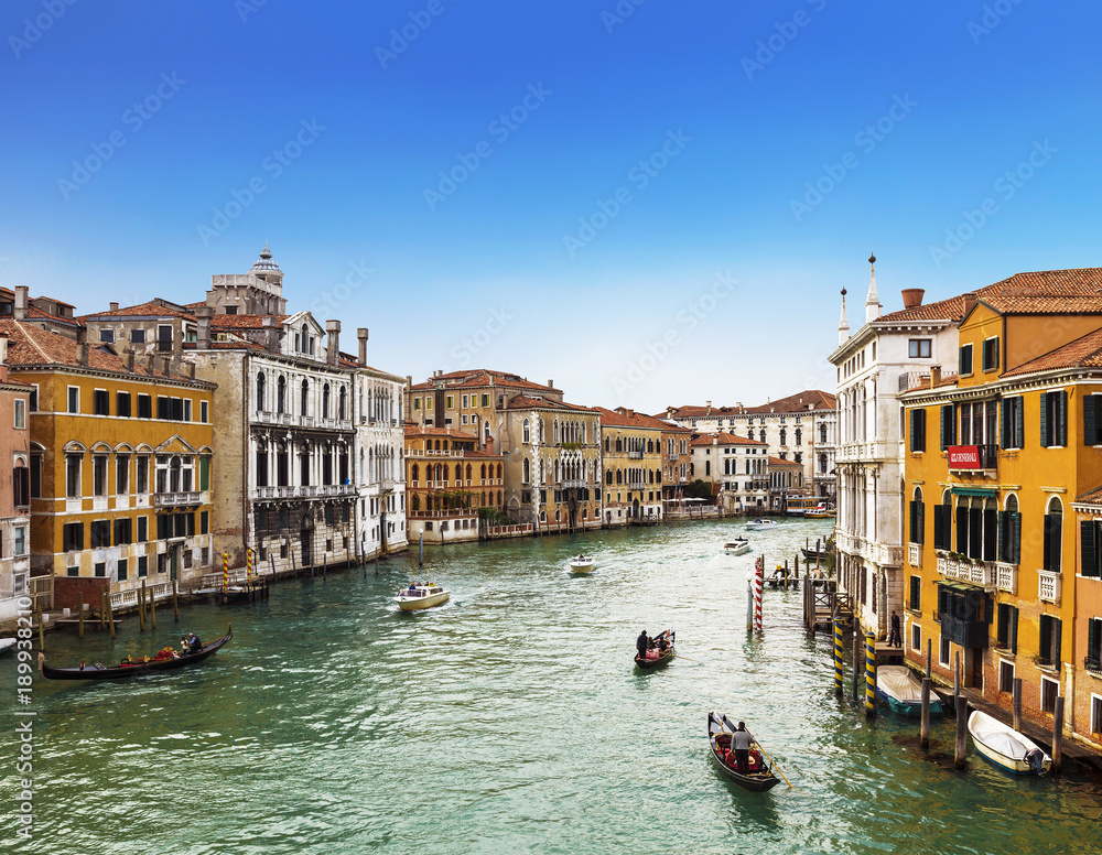 View from above on the Grand Canal, floating gondolas and boats with tourists, Venice, Italy