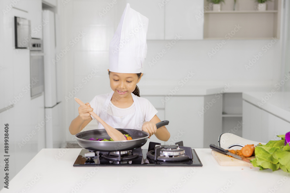Little girl cooking healthy meal in the kitchen Little girl cooking healthy meal in the kitchen
