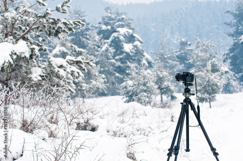 Winter landscape, camera on tripod in focus, big snow, cold weather.