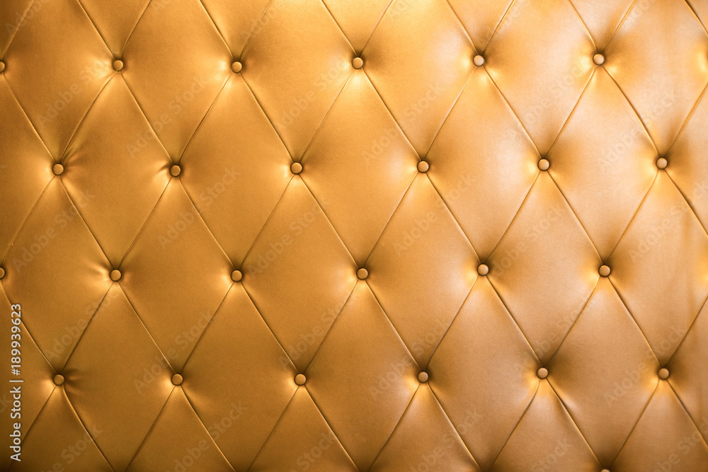 Abstract background texture of an old natural luxury gold leather sofa with rhombs Abstract background texture of an old natural luxury gold leather sofa with rhombs