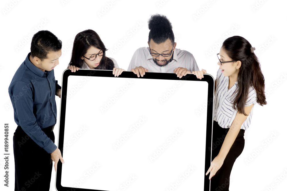 Business people holding whiteboard on studio Business people holding whiteboard on studio