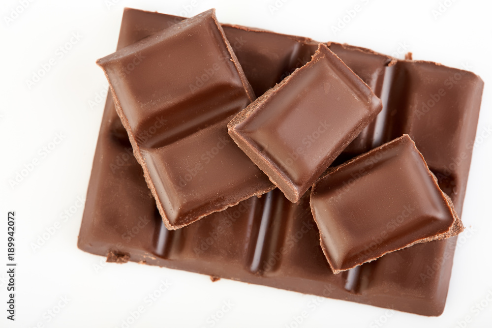 Milk chocolate pieces isolated on white background. Milk chocolate pieces isolated on white background.