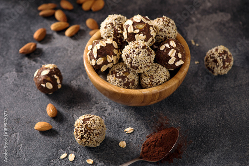 Vegan sweet bites, raw eating dessert with nuts and cacao, sesam and oats