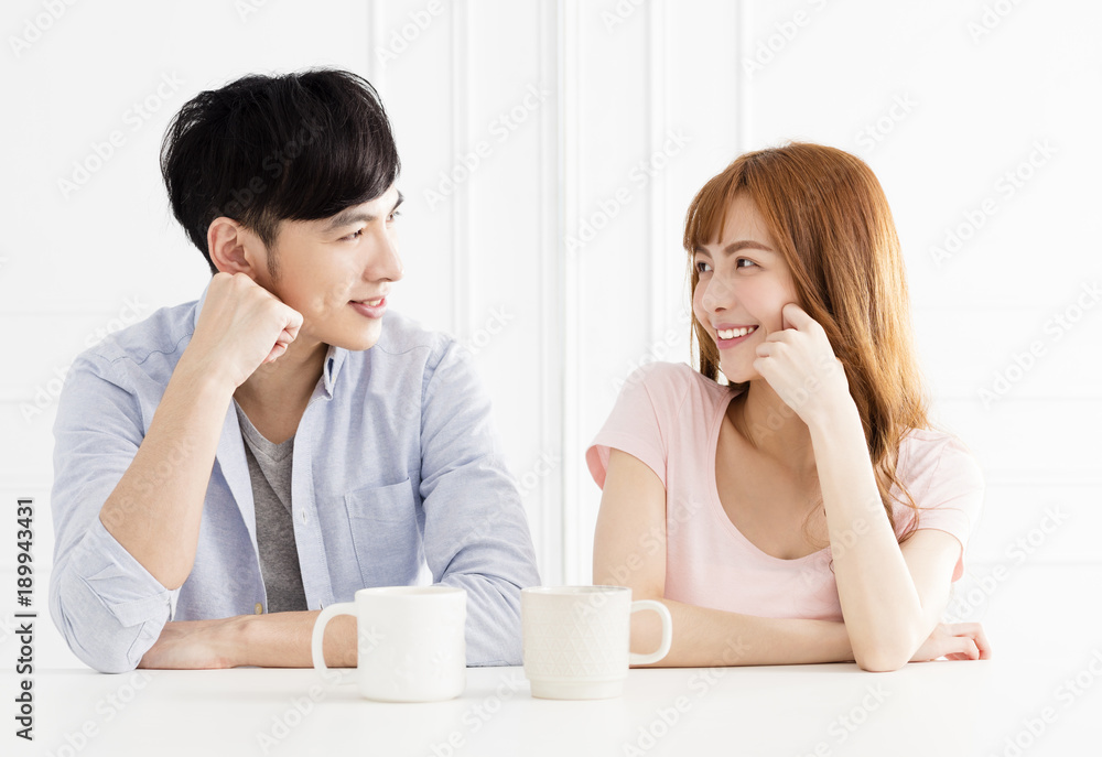 young asian couple drinking coffee in living room young asian couple drinking coffee in living room