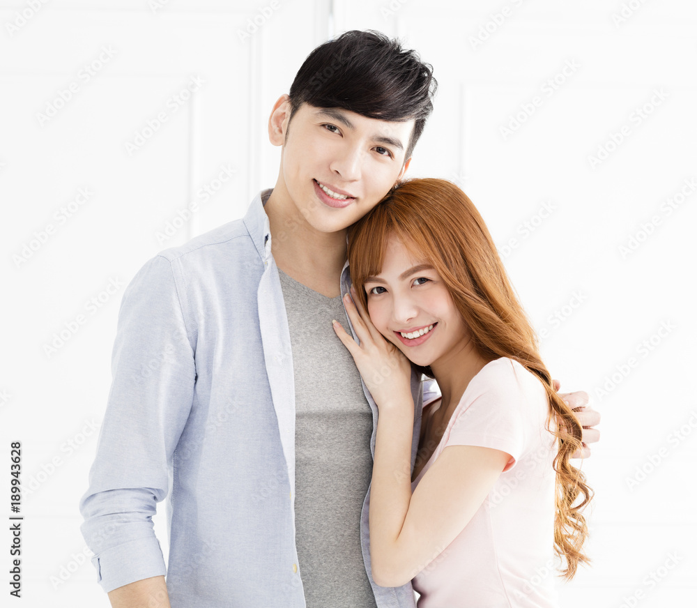 happy young asian couple hugging in living room. happy young asian couple hugging in living room.