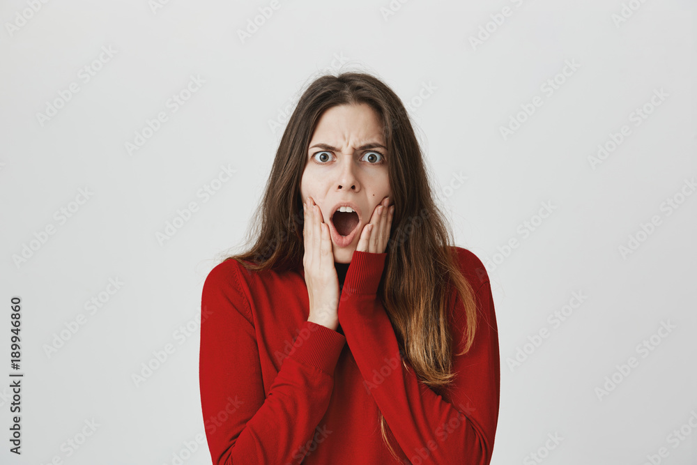 Portrait of attractive european girl holding hands on face, expressing shock, imitating scream picture, isolated over white background. It is her favorite peace of art. Represents all her mood Portrait of attractive european girl holding hands on face, expressing shock, imitating scream picture, isolated over white background. It is her favorite peace of art. Represents all her mood