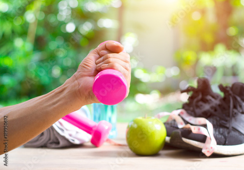 couple in the gym, rivaling each other, exercising with dumbbells photo