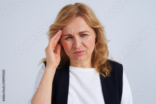 Mature blond with migraine