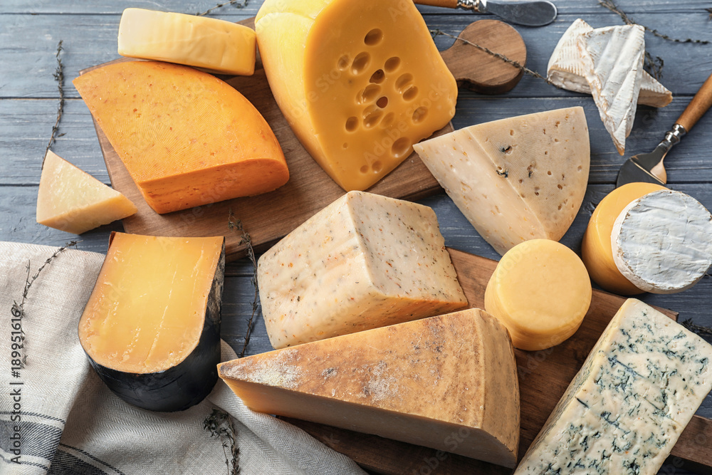 Fototapeta premium Different types of delicious cheese on wooden table