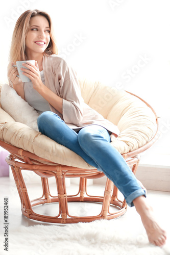 Happy young woman drinking ...