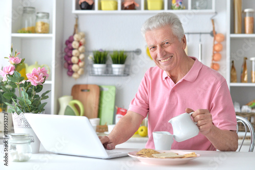 happy senior man using laptop 