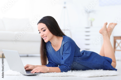 Young woman using laptop indoors