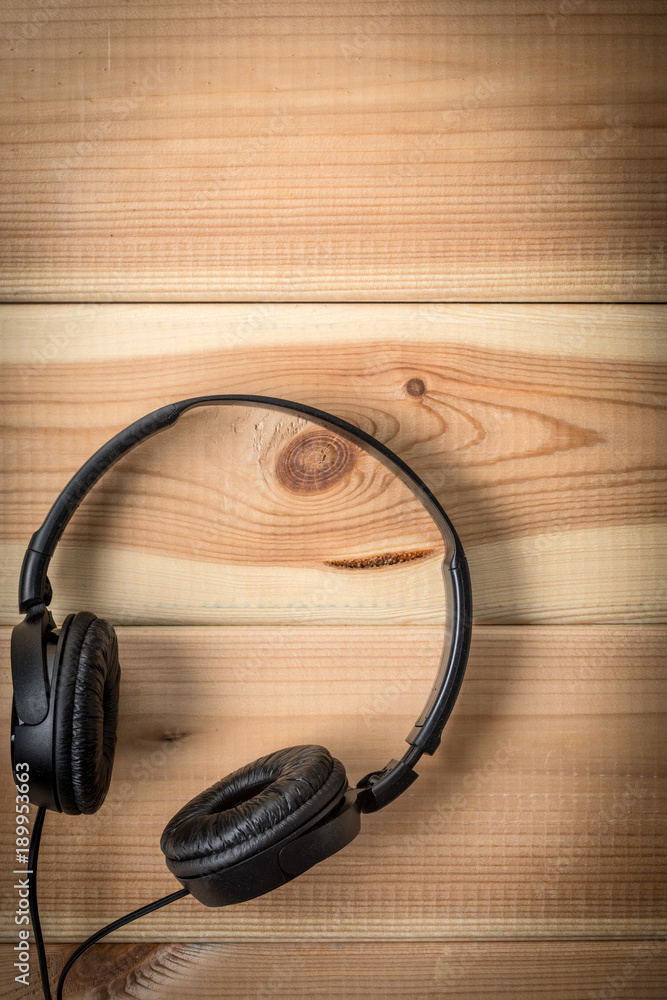 Black headphones on wooden background. Black headphones on wooden background.