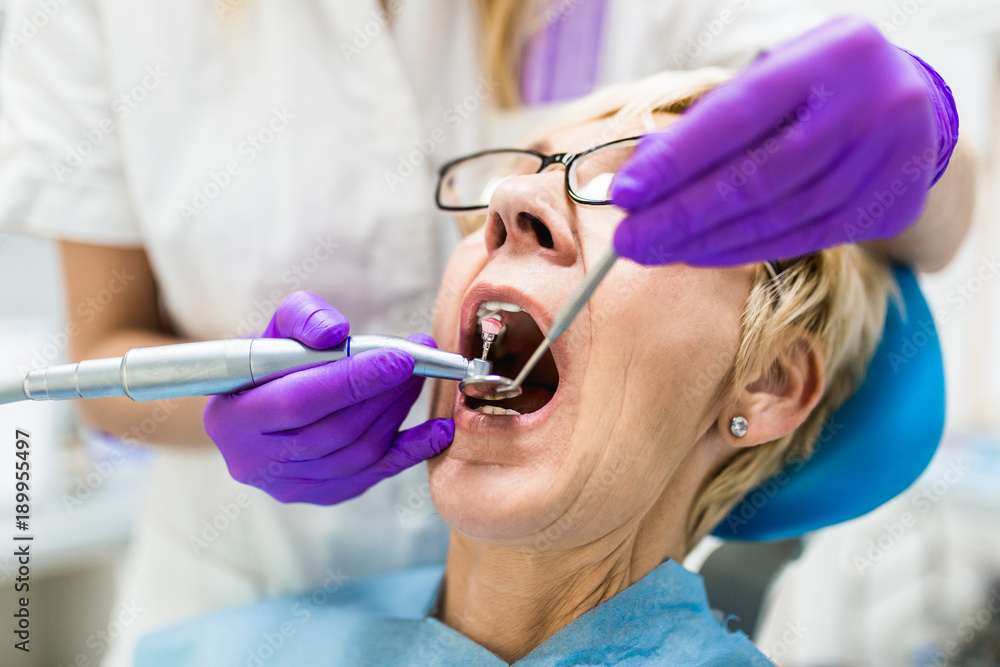 Senior woman having dental treatment at dentist's office. Senior woman having dental treatment at dentist's office.